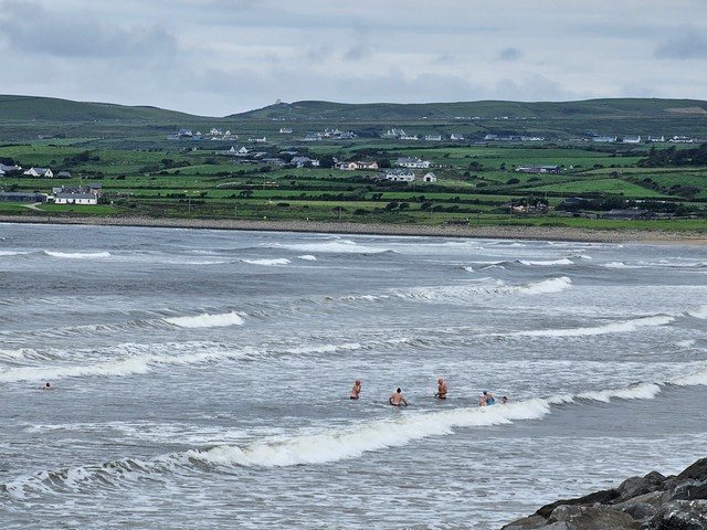 A few swimmers in the water but the tide is a little too high for the surfers